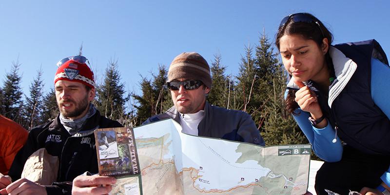 Cross-country skiers consulting a trail map