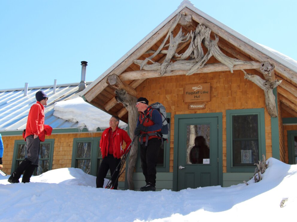 Skiers outside Flagstaff Lake Hut
