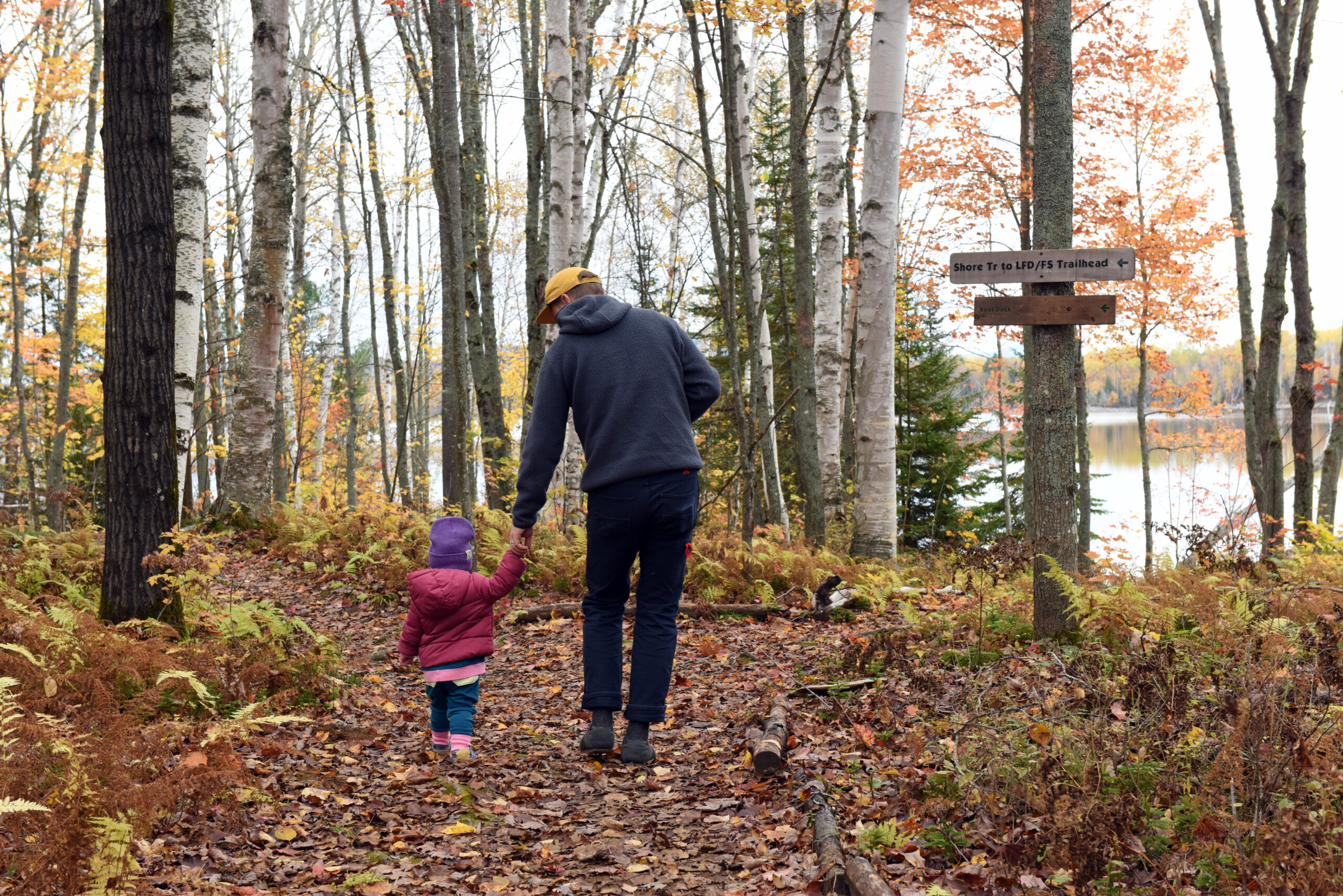 Family walking outside Flagstaff Lake Hut in fall
