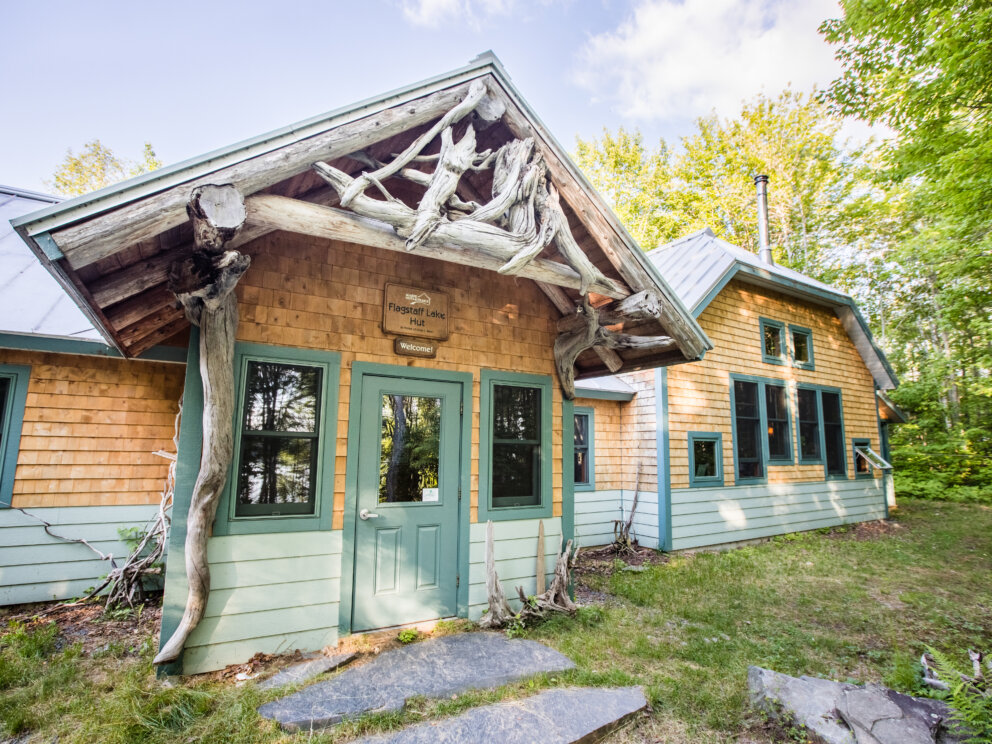 Flagstaff Lake Hut exterior in summer.