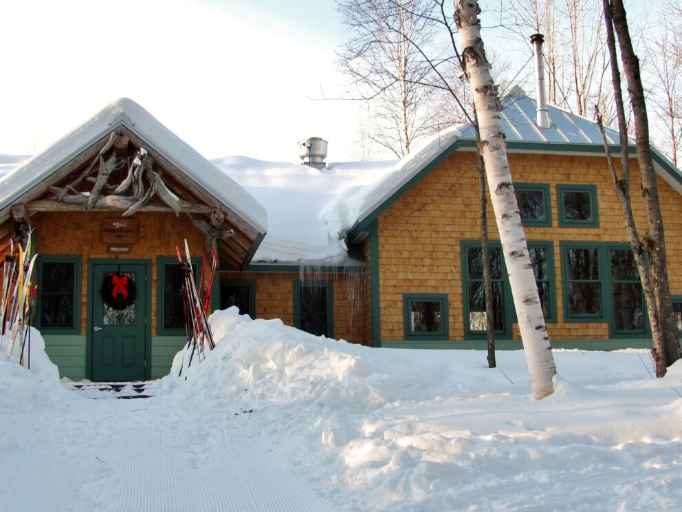 Flagstaff Lake Hut with skis and wreath.