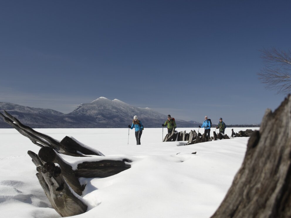 Snowshoeing on Flagstaff Lake with the Bigelow Range in the background.