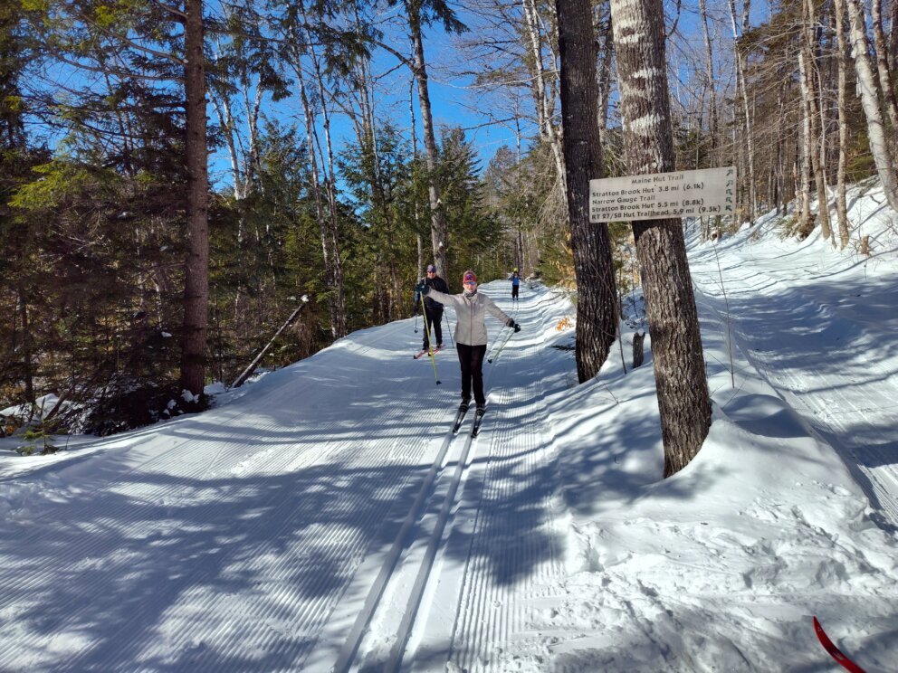 Skiers at the intersection of the Narrow Gauge Pathway and Crommett's Overlook Trail.