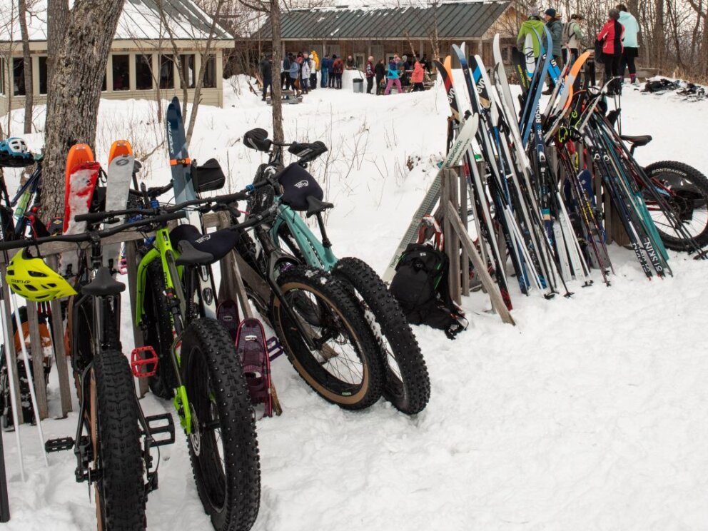 Fat bikes and skis on the rack outside Stratton Brook Hut for the Alpine Feast.