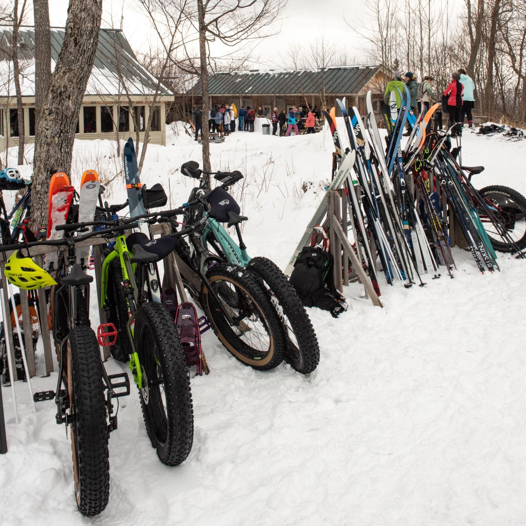 Fat bikes and skis on the rack outside Stratton Brook Hut for the Alpine Feast.