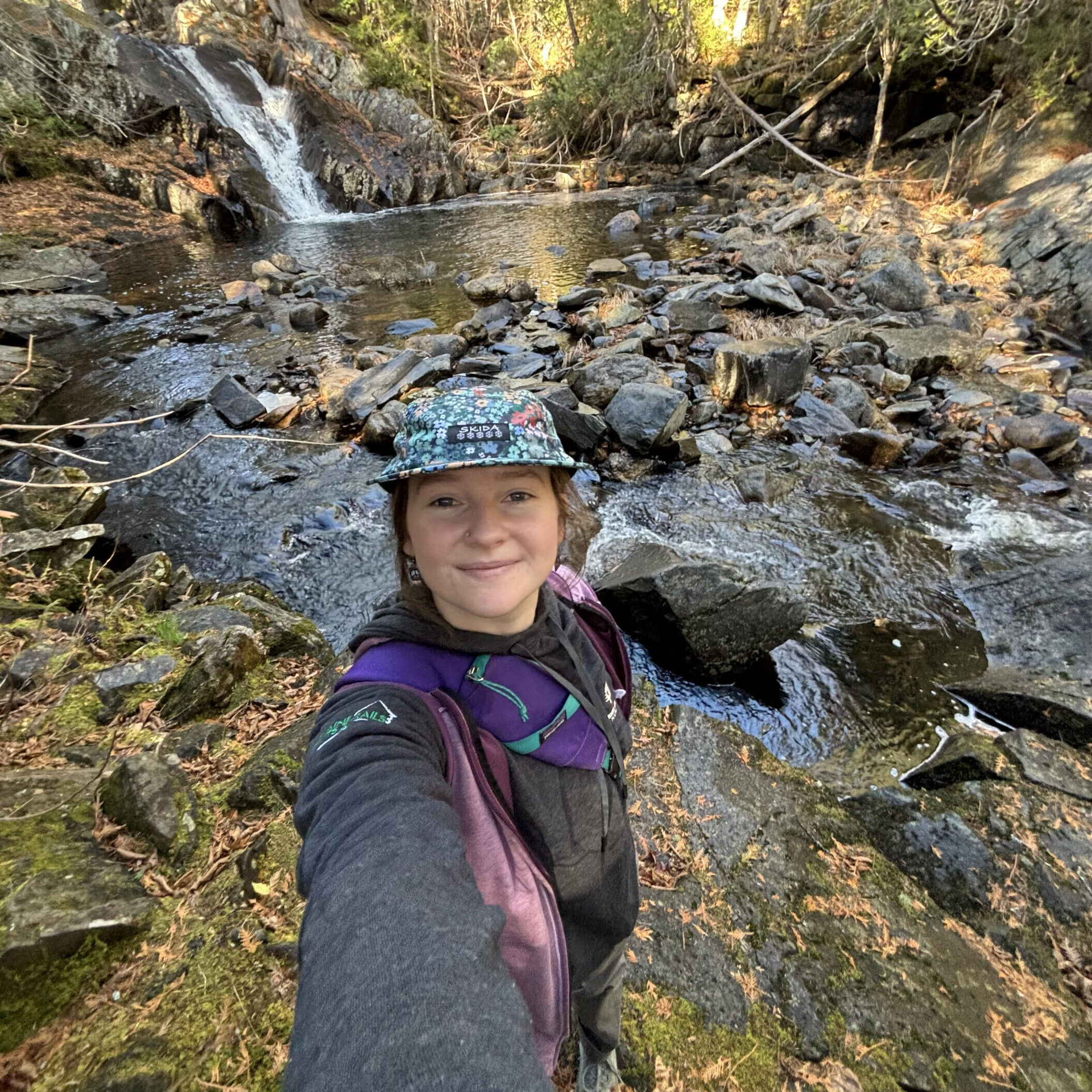 Hut staff by a waterfall