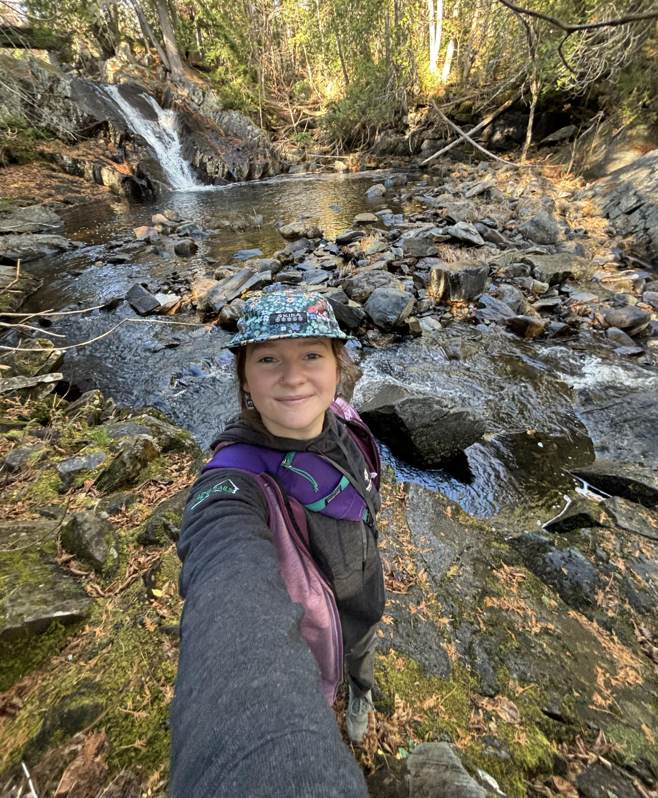 Hut staff by a waterfall