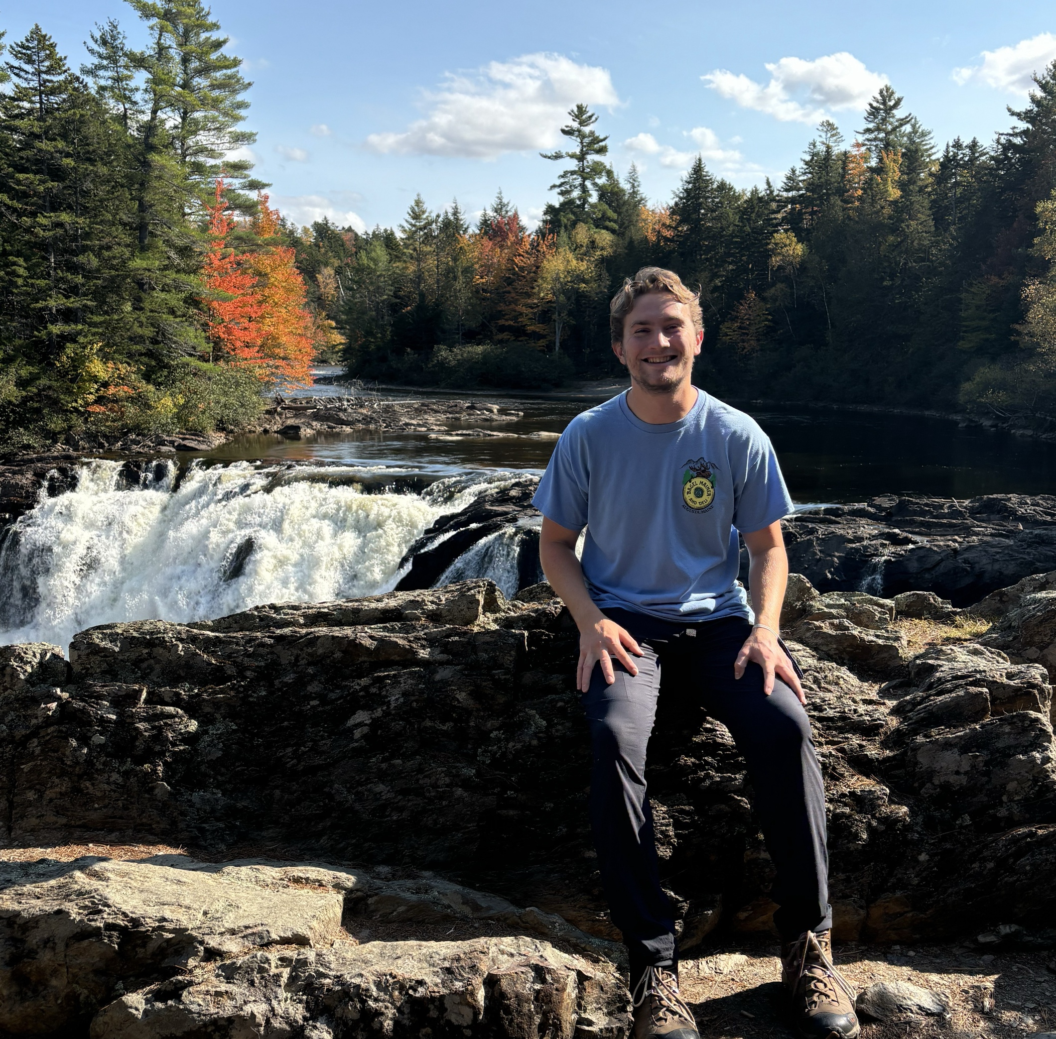 Hut staff by a waterfall