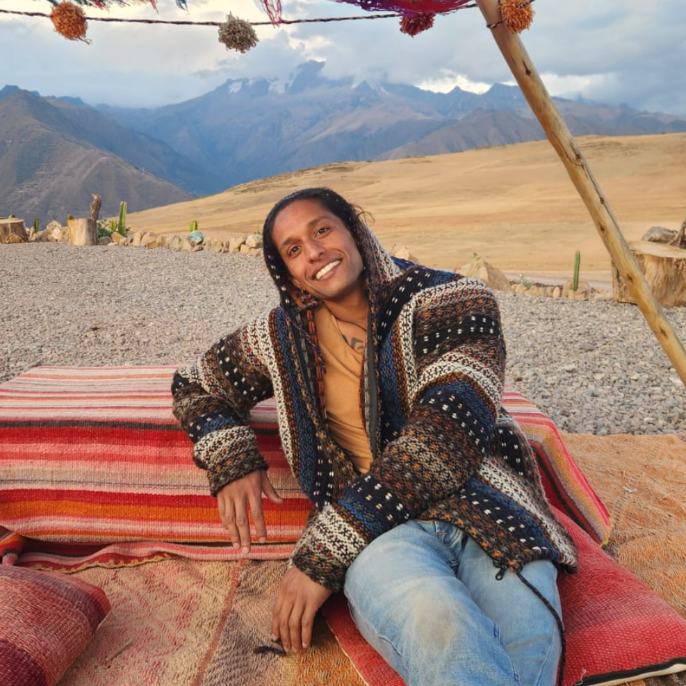 Hut staff sitting in front of mountains