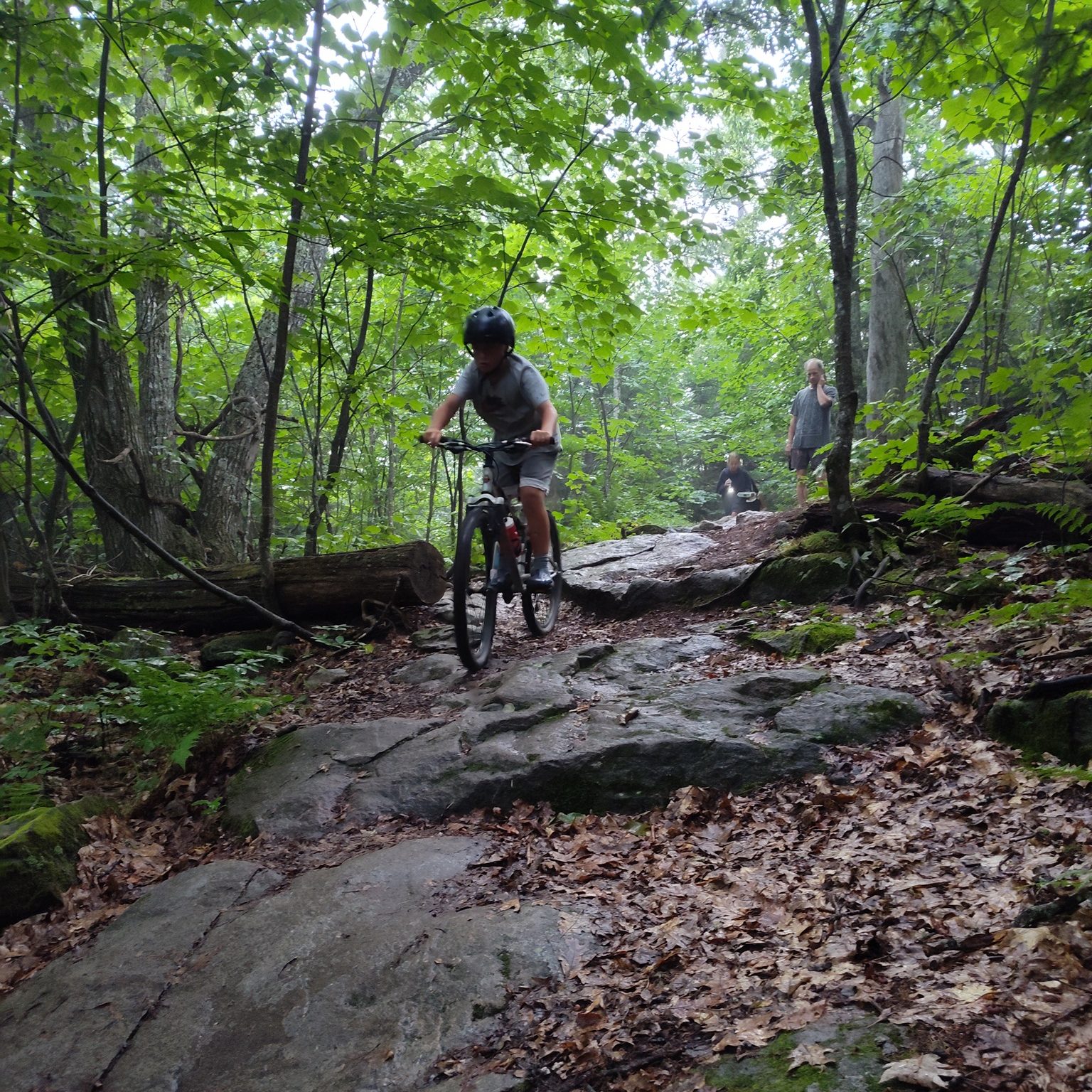 Mountain biking down a rocky trail