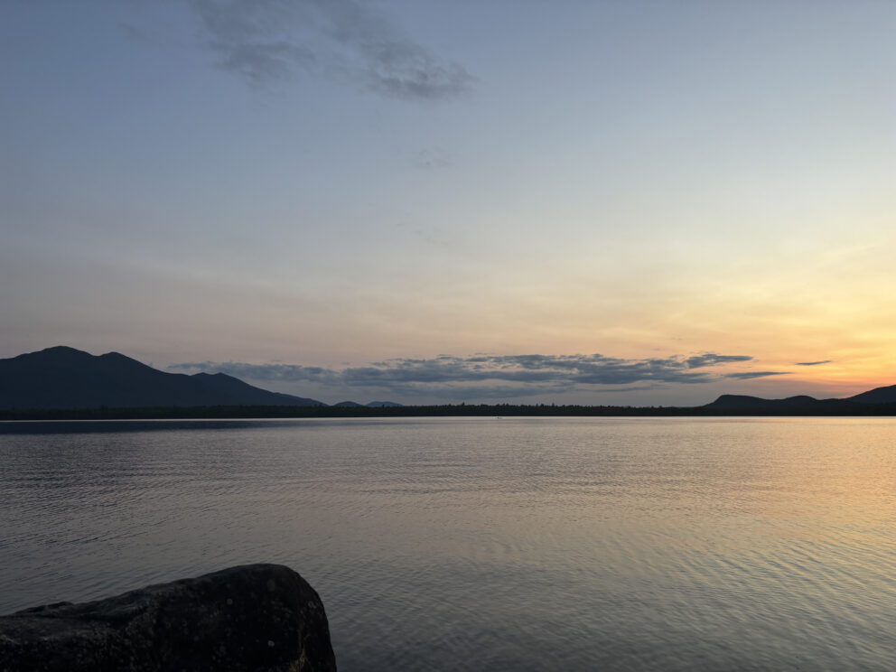 Sunset on Flagstaff Lake with Mountains in the background.