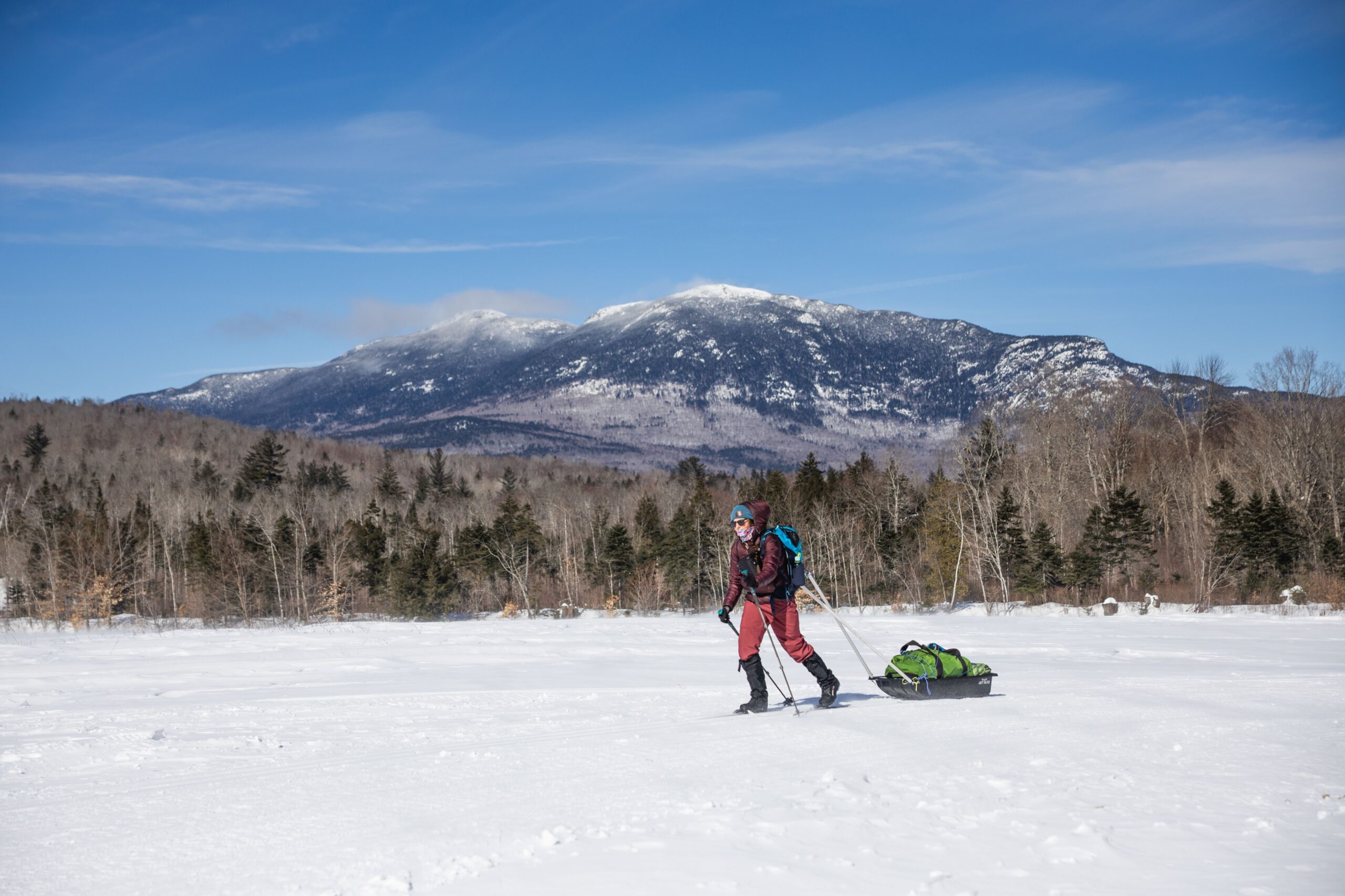 Cross country skier heading to the Airport Trailhead with gear sled.