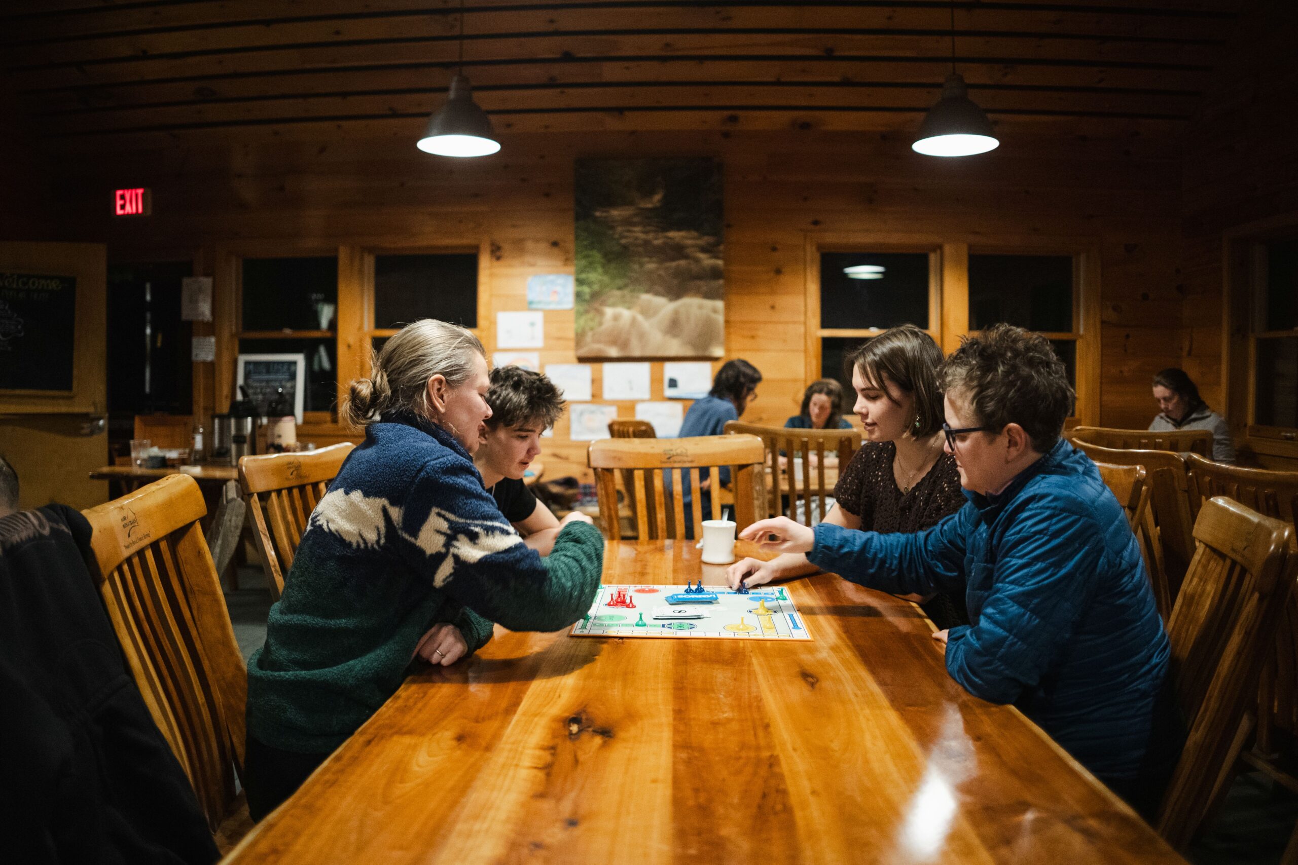 Playing games inside at Poplar Stream Hut