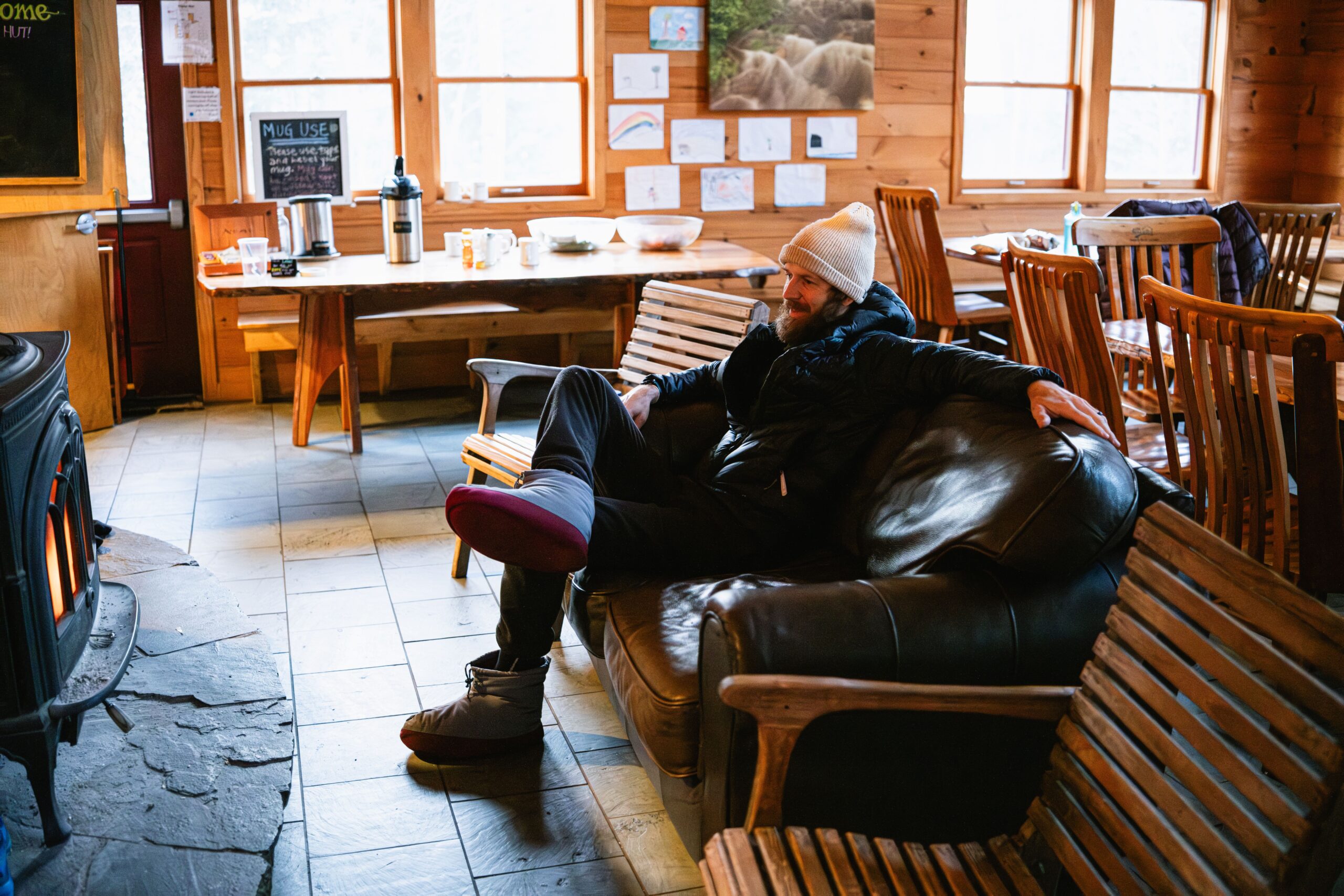 Relaxing in front of the wood stove at Poplar Stream Hut