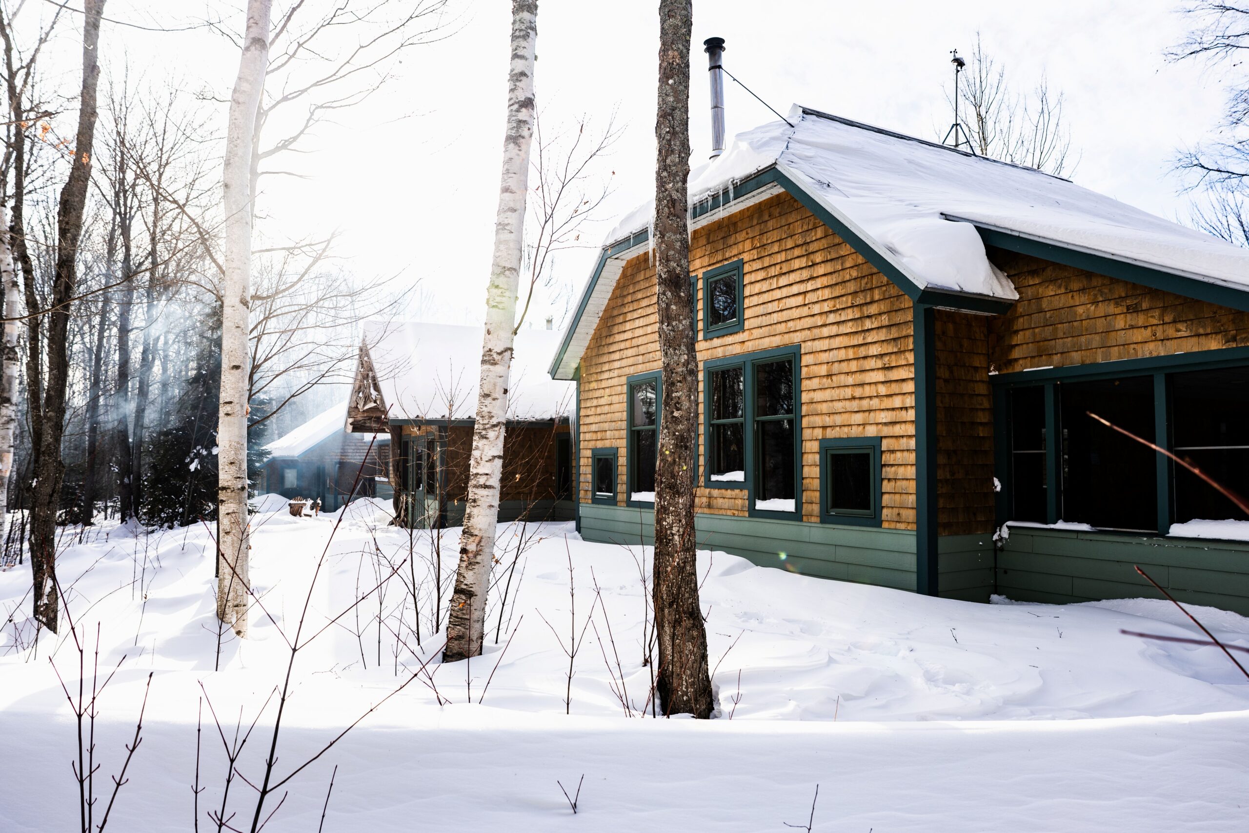 Exterior view of Flagstaff Lake Hut on a snowy winter day.