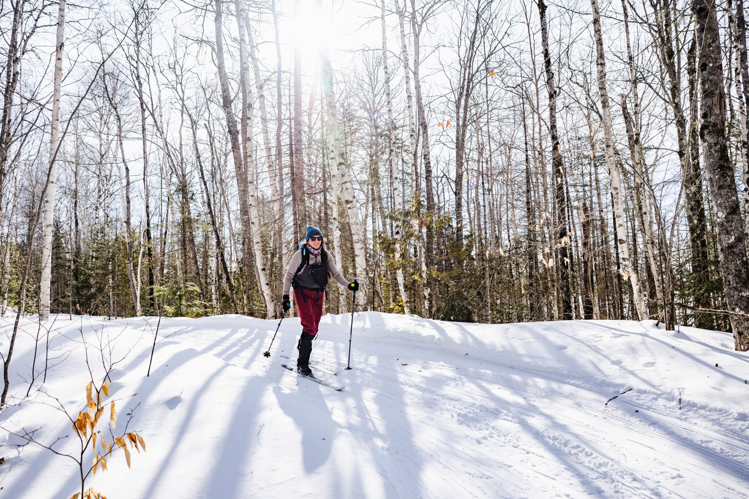 Single skier on the groomed Maine Hut Trail in winter.