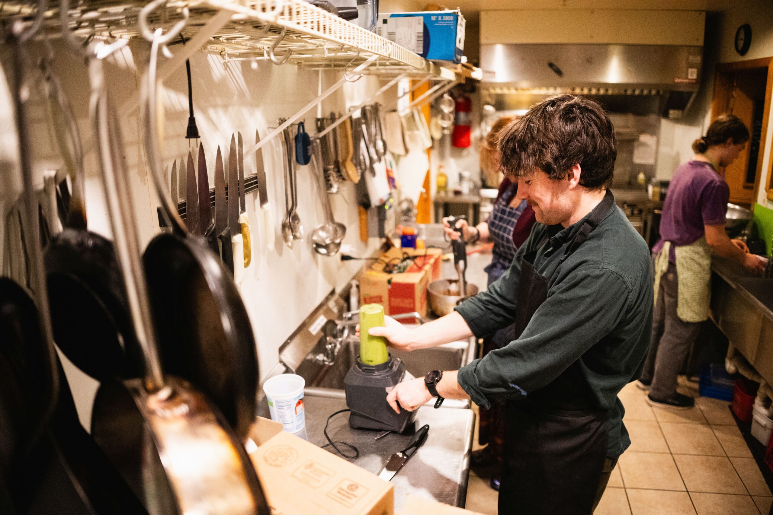 Hut staff making dinner in the kitchen at Poplar Stream Hut.