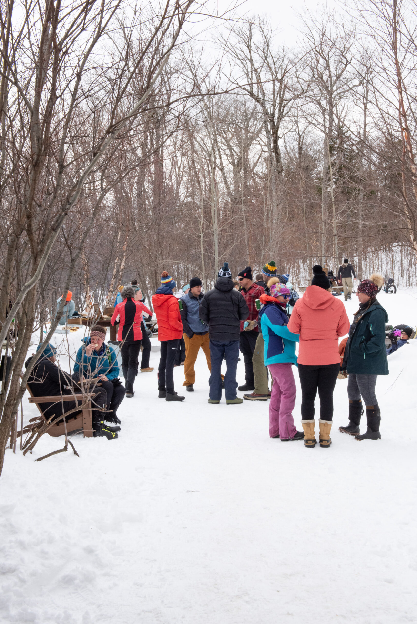 Guests mingle outside Stratton Brook Hut during the Alpine Feast