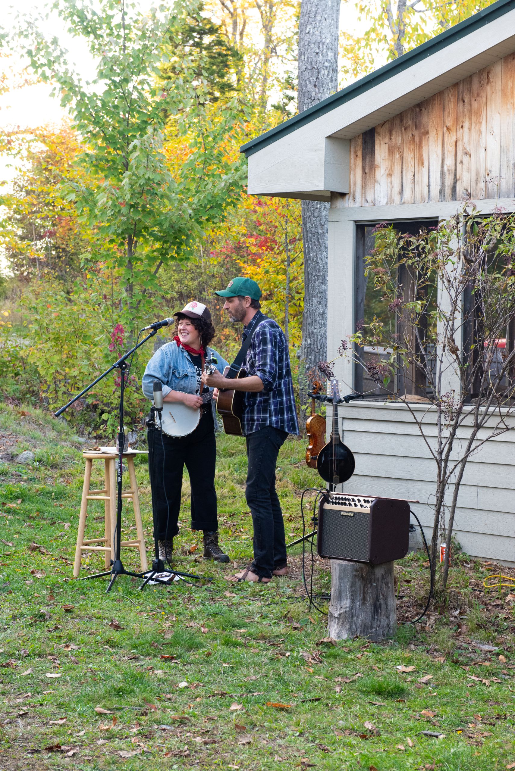 Band Landline playing string instruments outside Stratton Brook Hut