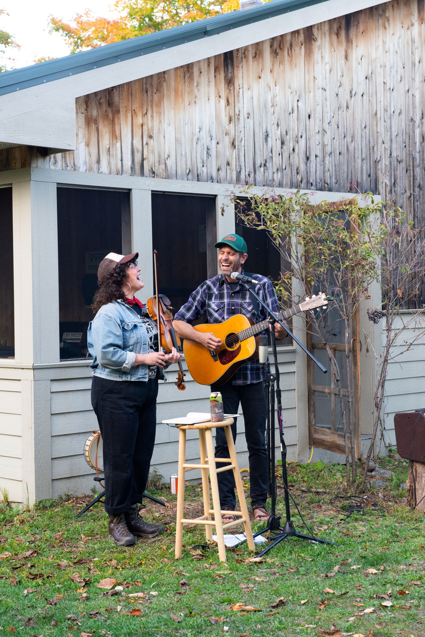 Band Landline playing string instruments outside Stratton Brook Hut
