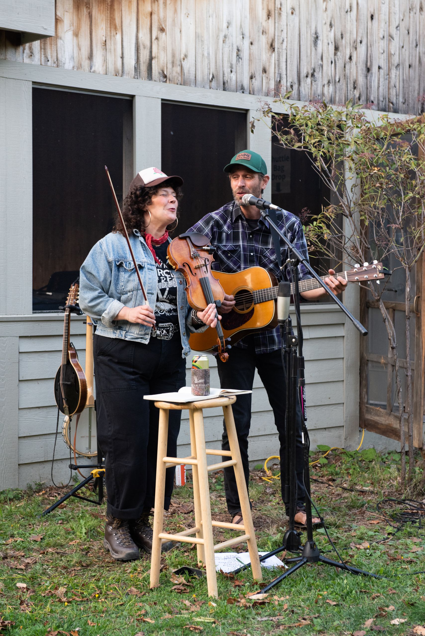 Band Landline playing string instruments outside Stratton Brook Hut