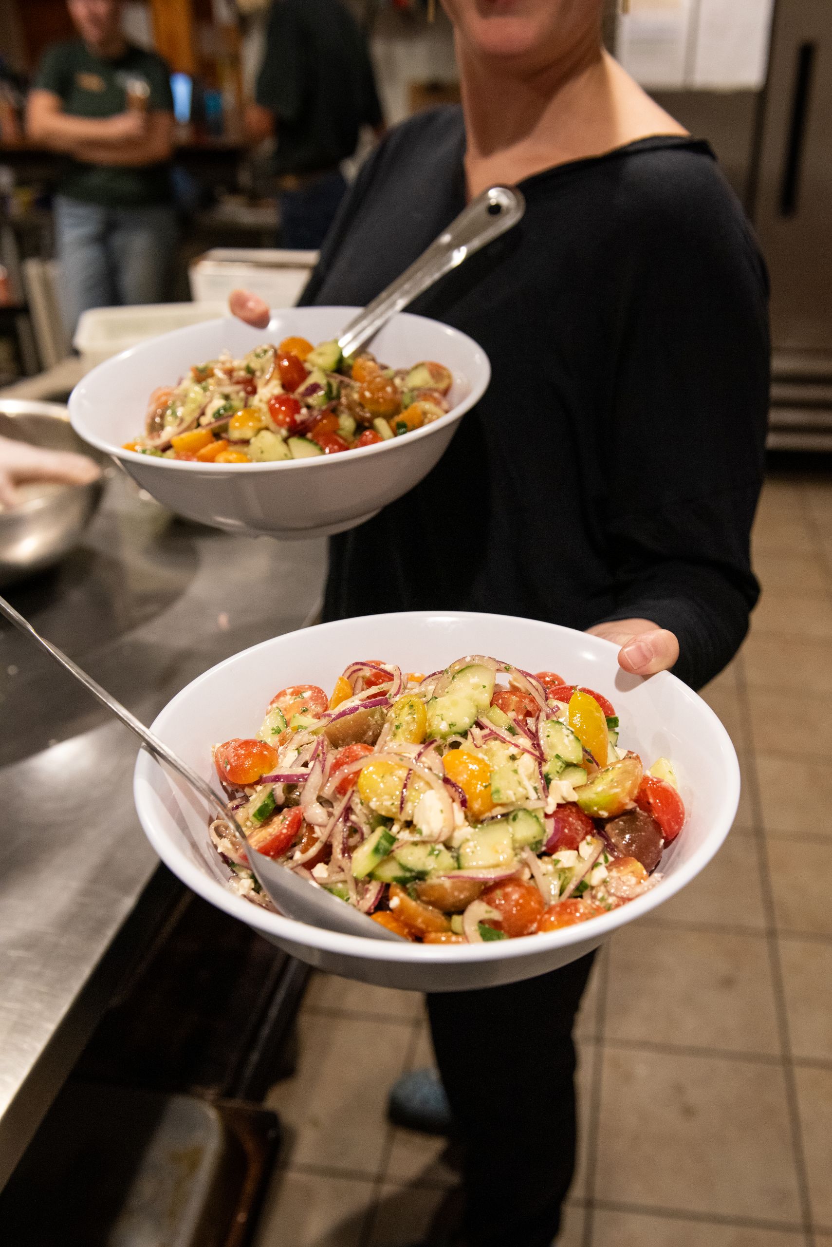 Bowls of feta, tomato and cucumber salad at Harvest dinner