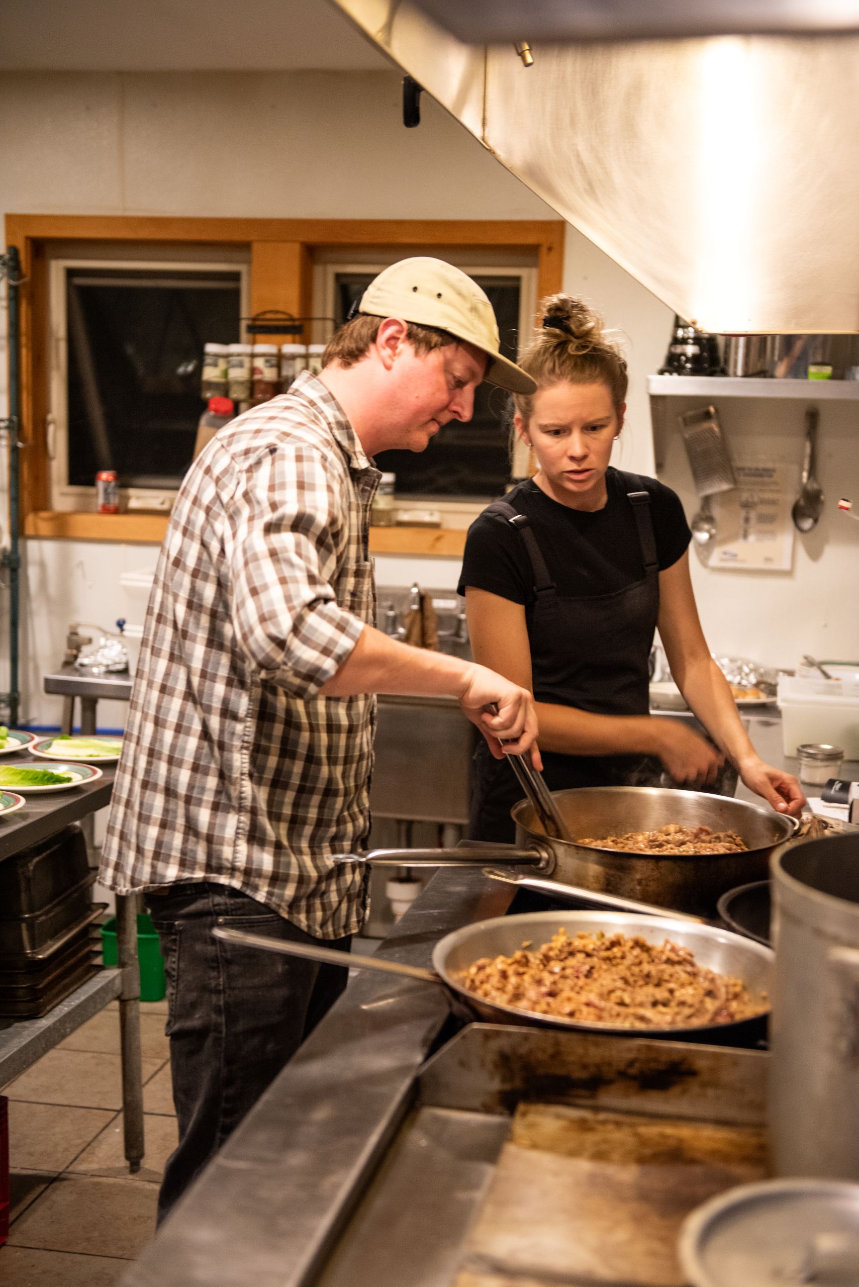 Chef Spencer Lee and Kayla working in the kitchen for Harvest dinner.