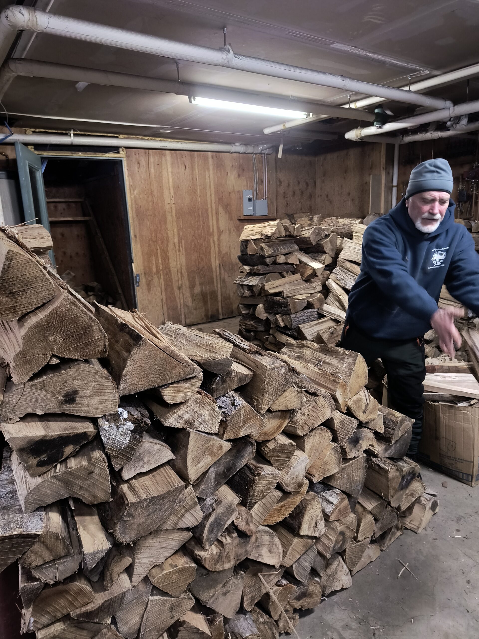Volunteer Jon LaRochelle stacking firewood