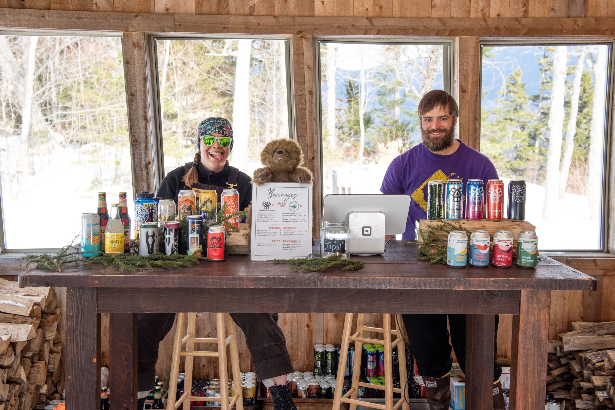 The bar at Alpine Feast 2026 with hut staff.