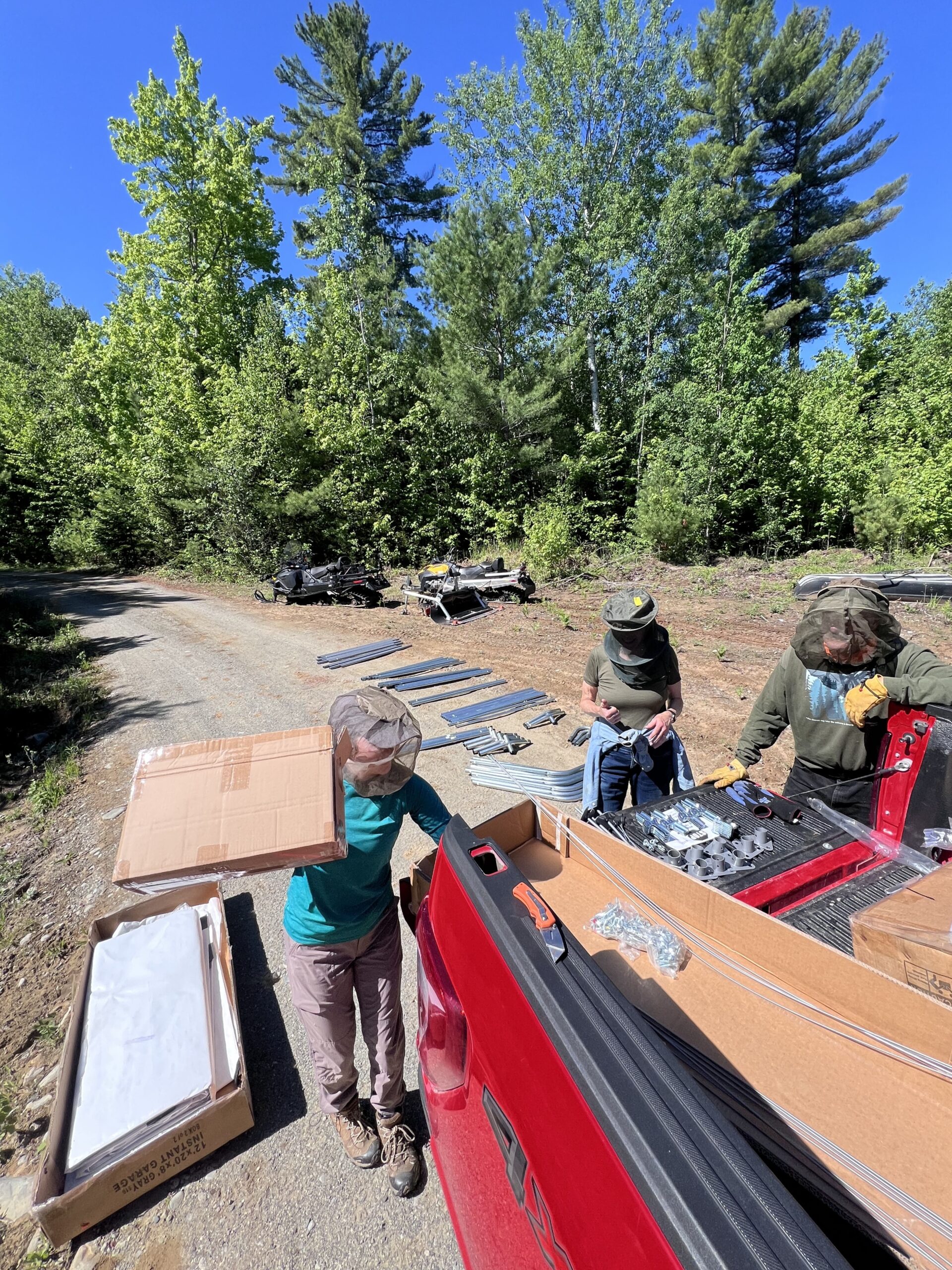 Assembling the snowmobile shelter at the volunteer overnight at Flagstaff Lake Hut