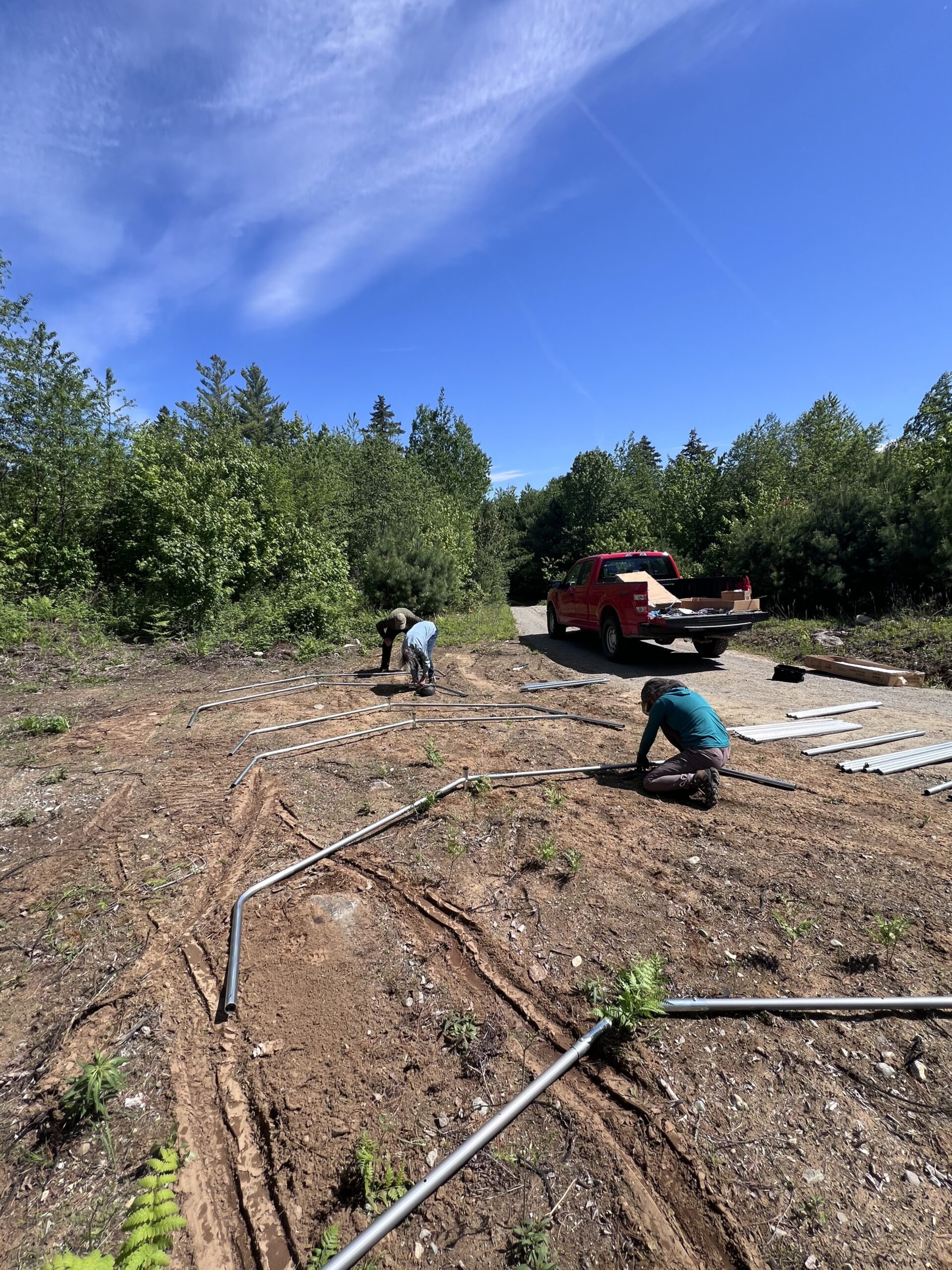 Assembling the snowmobile shelter at the volunteer overnight at Flagstaff Lake Hut