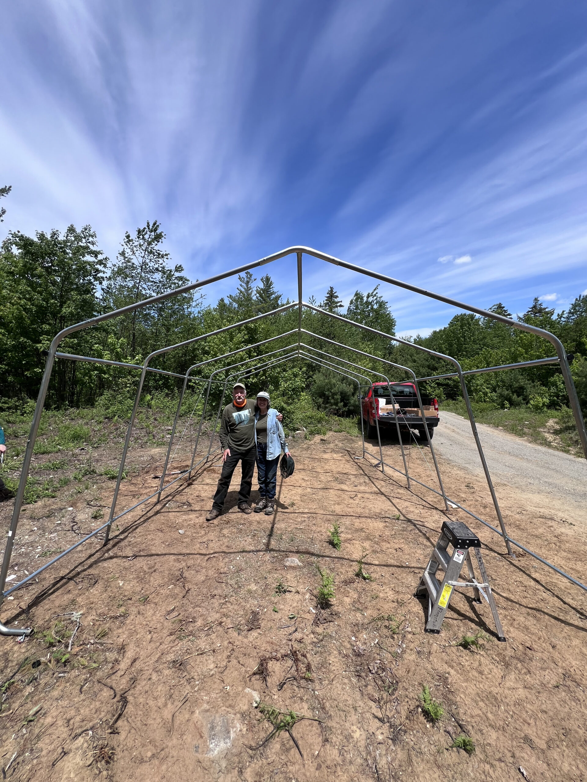 Assembling the snowmobile shelter at the volunteer overnight at Flagstaff Lake Hut