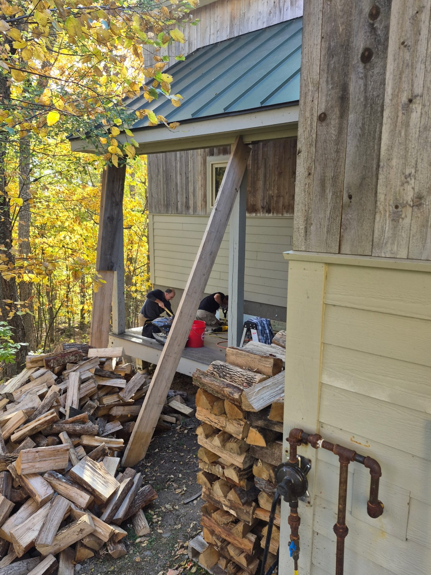 Board members repairing the deck at Stratton Brook Hut.